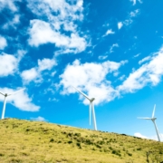 Wind turbines on rolling hills during a clear day