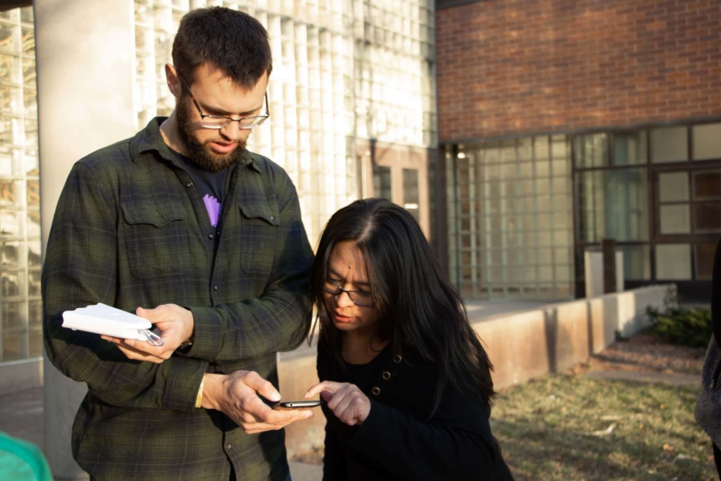 Two students collect air quality data