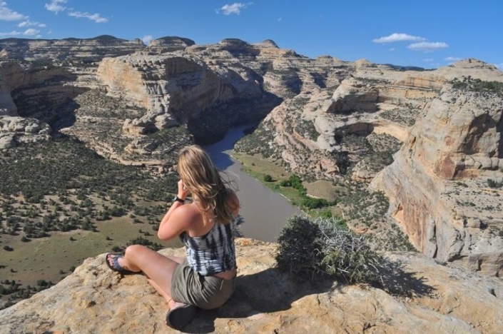 A person sits and overlooks a gorge in Dinosaur National Monument