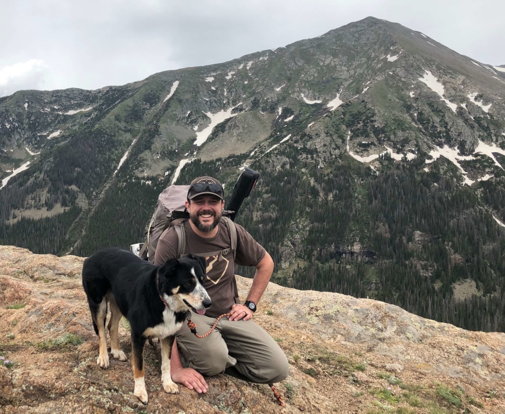 Pete Scales with his dog, Ruby, with a beautiful mountain vista. 