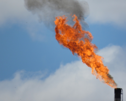 Methane flare billowing out fire and smoke