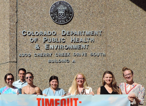 People standing in front of the Colorado Department of Public Health and Environment