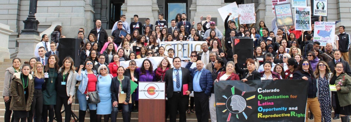 Advocates gather around a podium to celebrate Latino Advocacy Day 2019