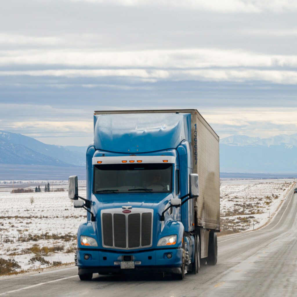 A truck driving through a mountainous landscape.