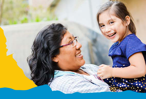 Photo of woman holding a child and both smiling