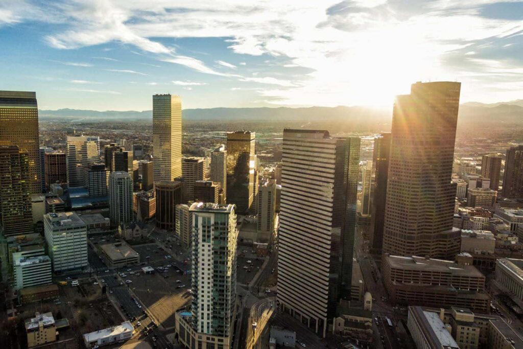 Photograph of sunset behind Denver skyscrapers
